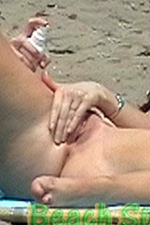 Lewd ladies touch herself at nude beach