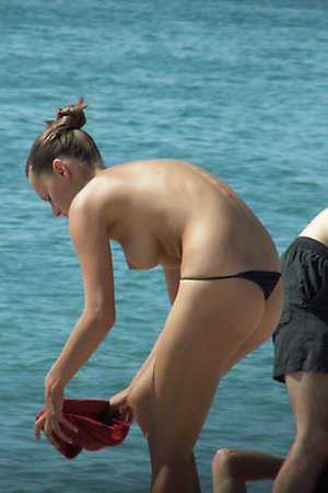 Naked babes enjoy ocean water