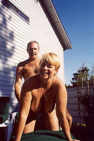 Pretty mature nudists posing outdoors