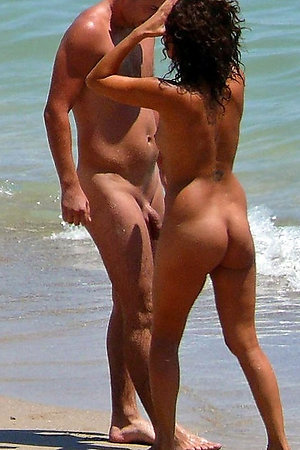Naked girls spreads legs on the beach