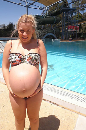 Pregnant nudist girls in a outdoor pool
