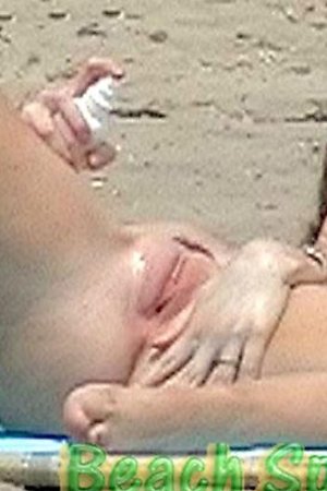 Lewd ladies touch herself at nude beach