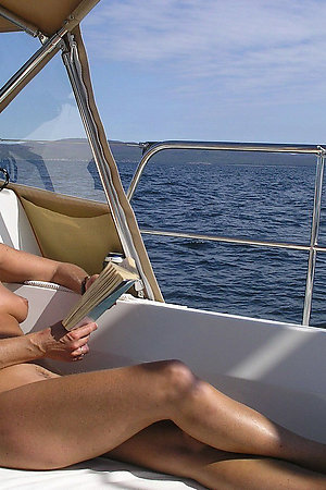 Nude mature women on their nudist boat