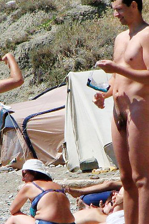 Nudist cutie takes off her clothes at public beach